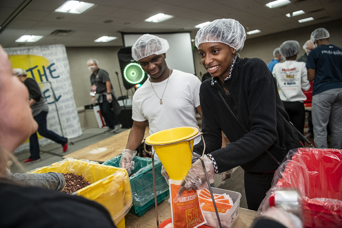 Students volunteering to pack meals for the needy